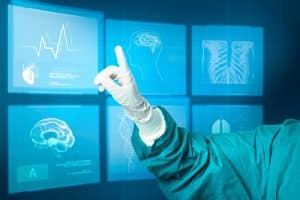 Gloved hand pointing to digital medical interface showing health data analytics