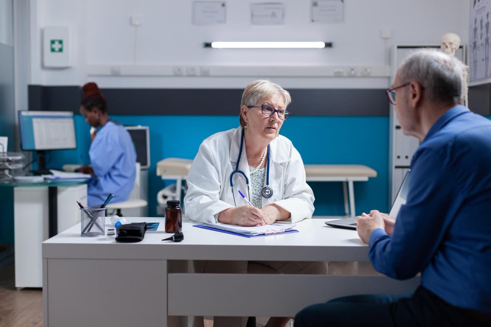 Medical professional signing checkup papers to authorize prescription medication