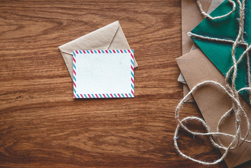 Vintage envelopes and letters on a wooden surface, flat lay