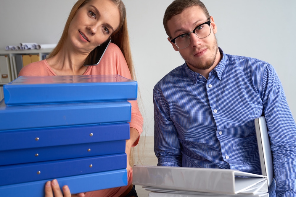 Man and woman reviewing medical records for an insurance claim