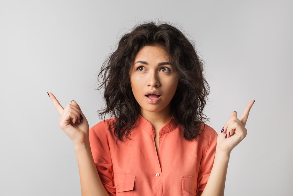 Young woman thoughtfully deciding between different options.