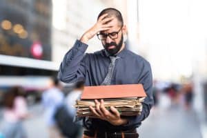Person searching through a messy pile of files