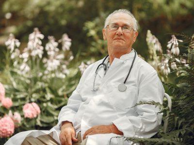 An-old-retiring-doctor-sitting-on-a-summer-park