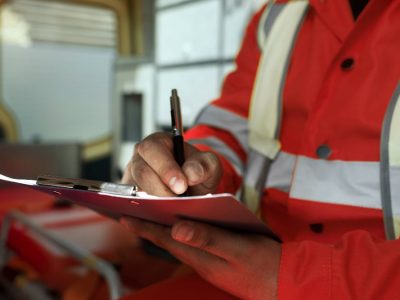 Side-view-man-taking-notes-in-ambulance-car